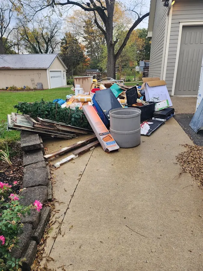 Dumpster being loaded with debris for 3 Yard Dumpster Rental in Ferguson